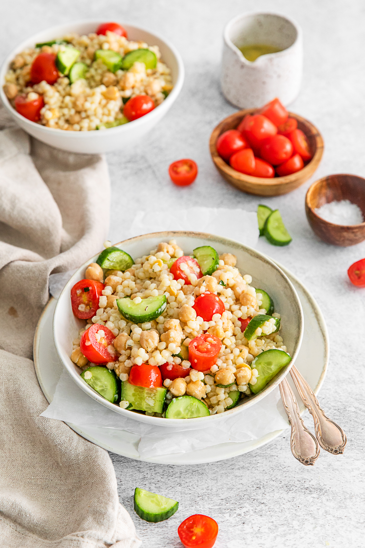 Mediterranean Couscous Salad served with extra tomatoes. 