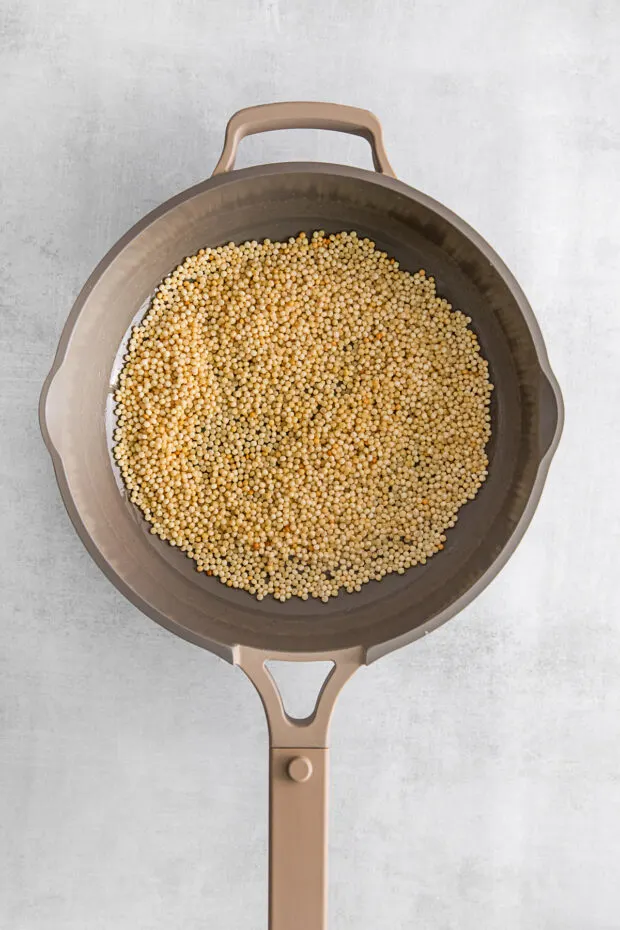 Toasted couscous in a pan. 
