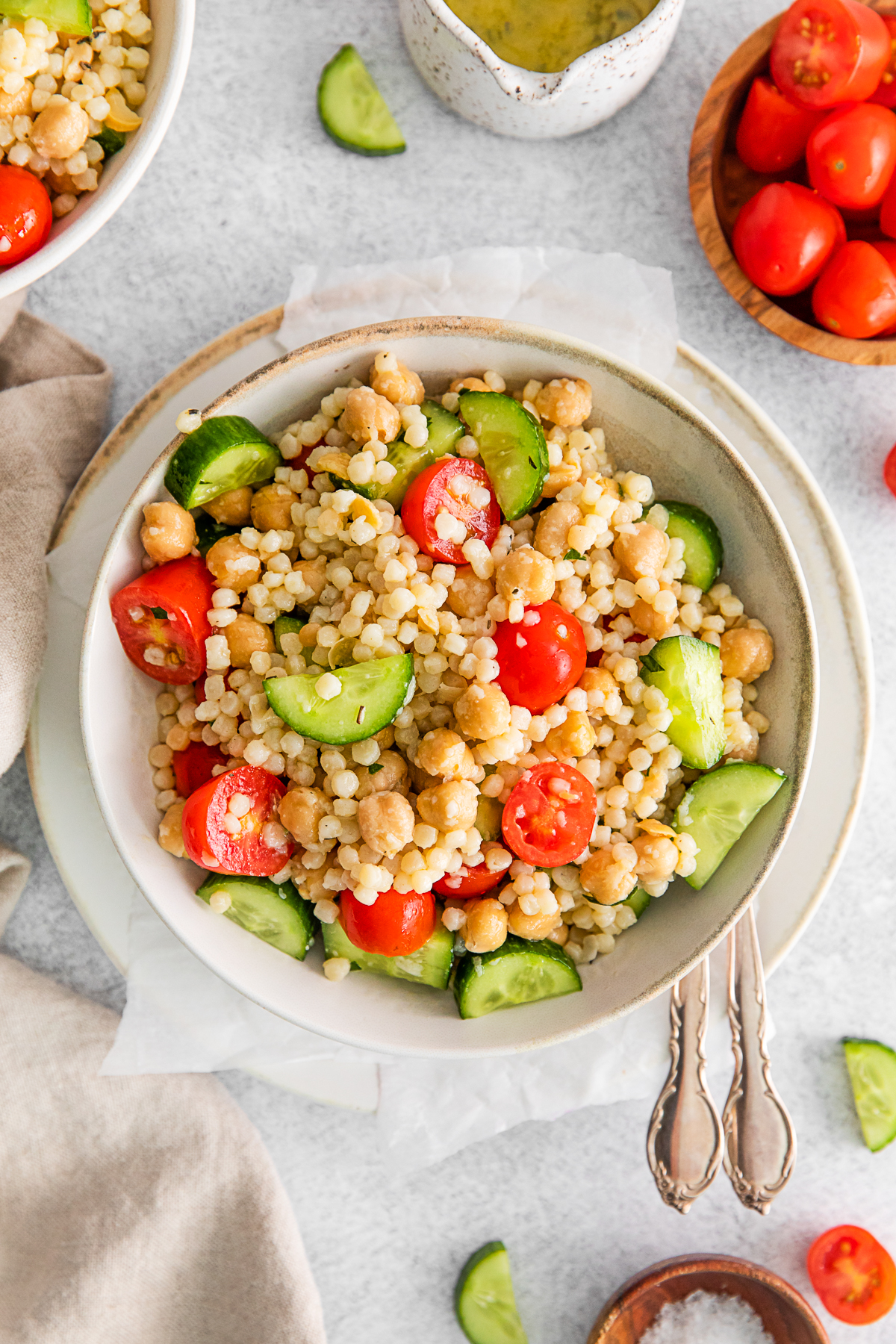 Mediterranean Couscous Salad in a tan colored bowl. 