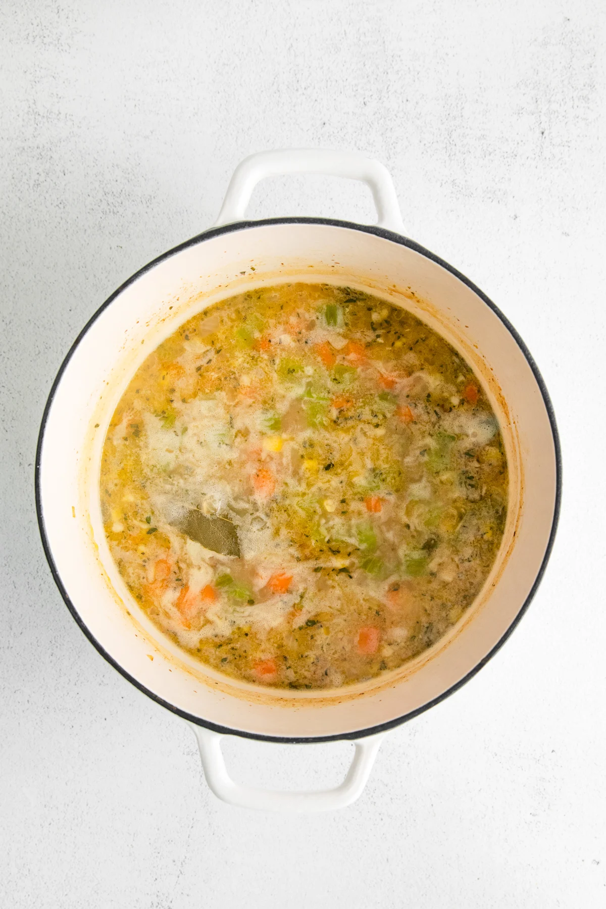 Soup in a pot with a bay leaf. 