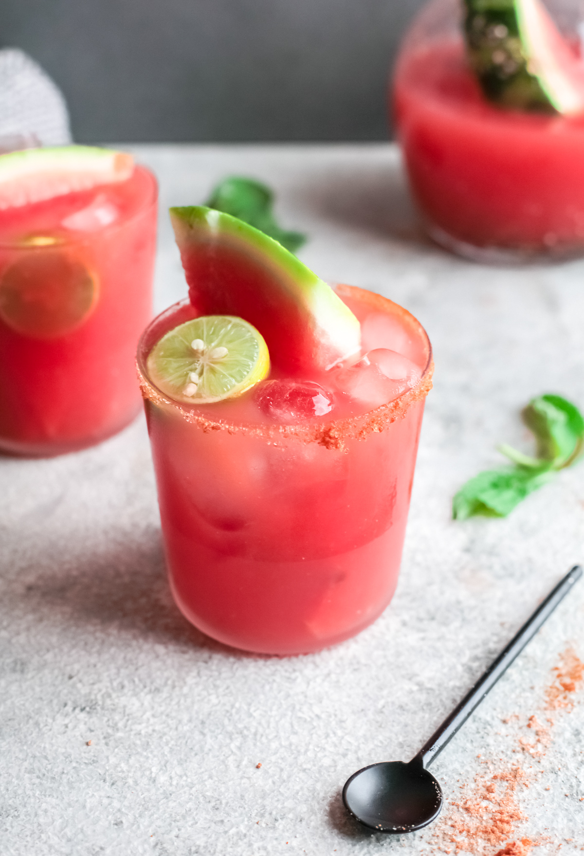 Watermelon Paloma in a glass with a lime wedge. 