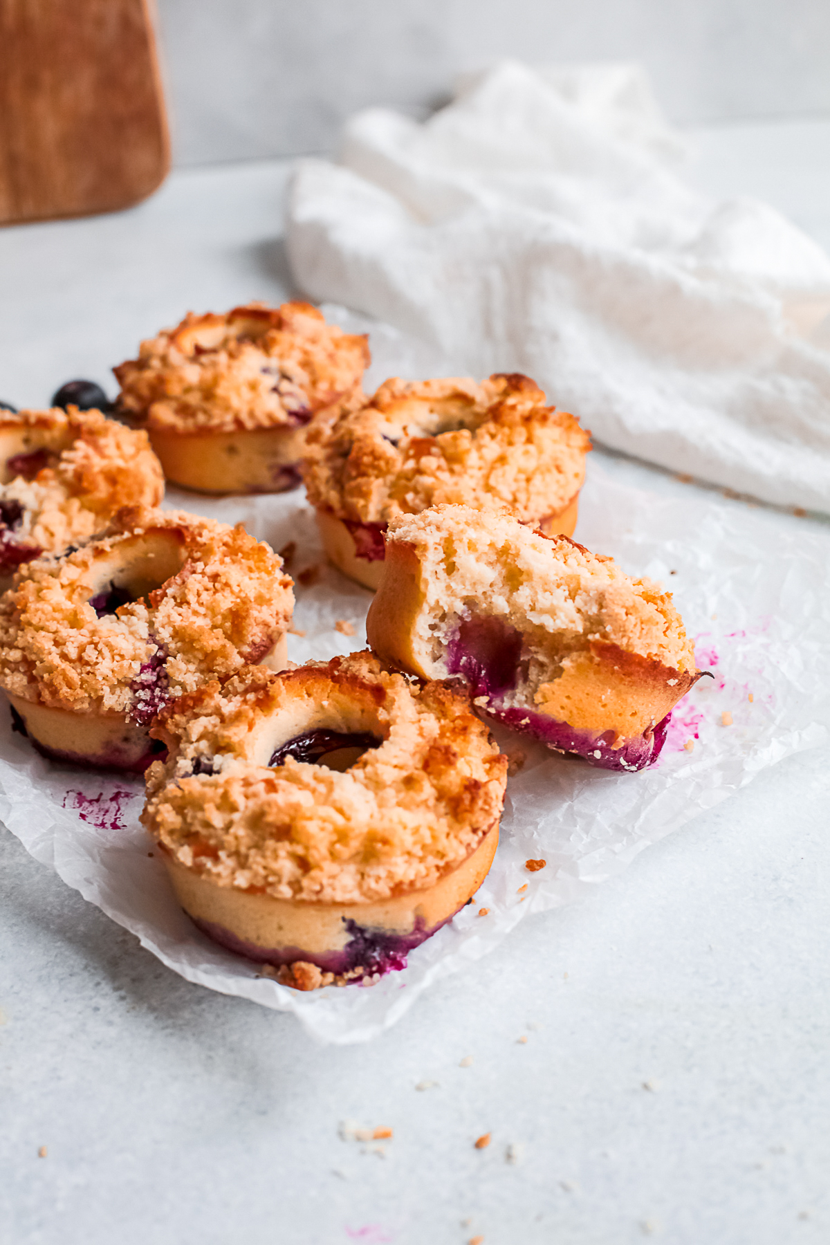 Baked Blueberry Streusel Donuts topped with crunchy topping. 