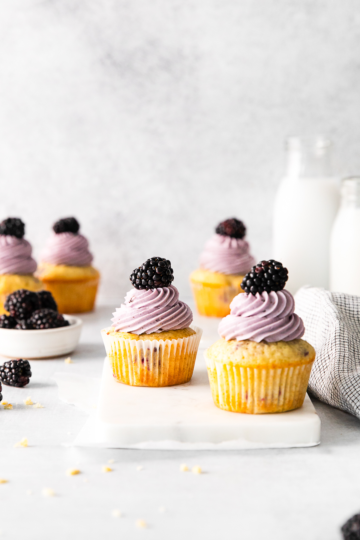Blackberry Cupcakes on a white serving tray. 