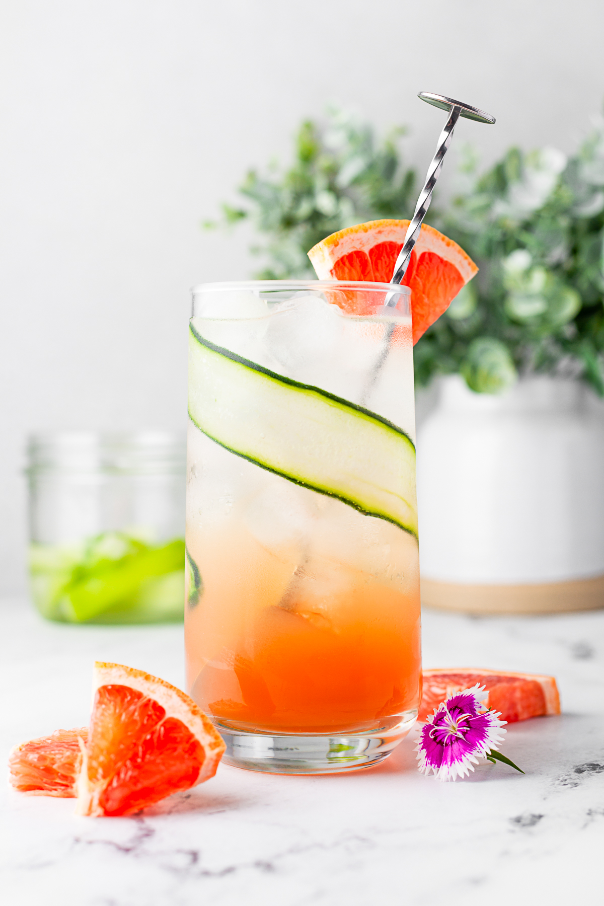 Grapefruit Gin Fizz in a glass garnished with fresh grapefruit. 