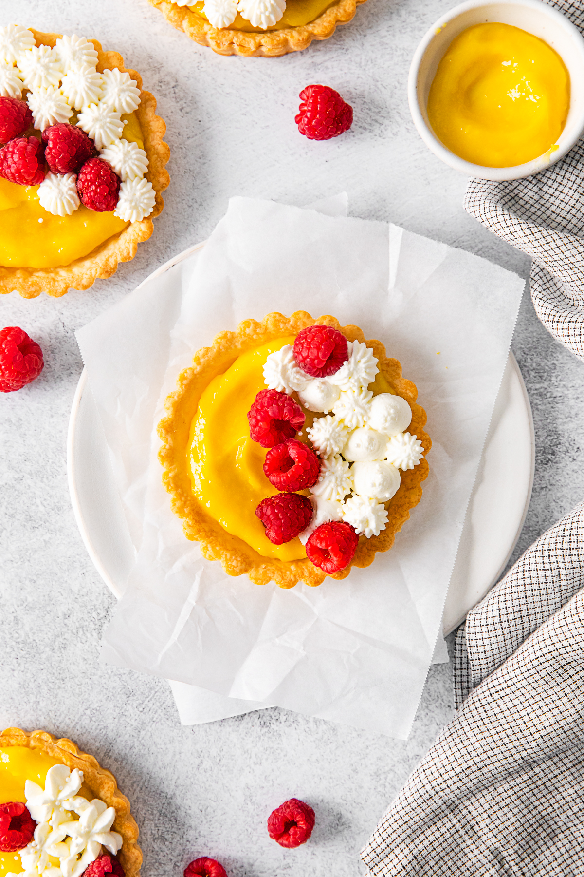 Lemon Curd Tarts topped with whipped cream. 