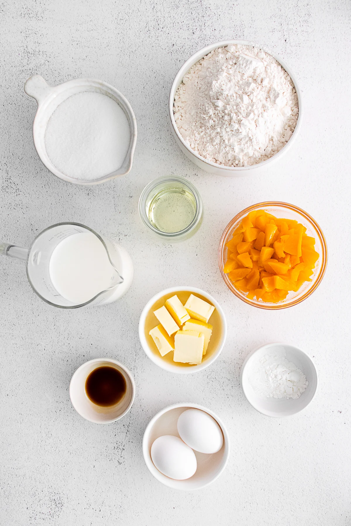 Ingredients to make Peach Streusel Muffins on a table. 