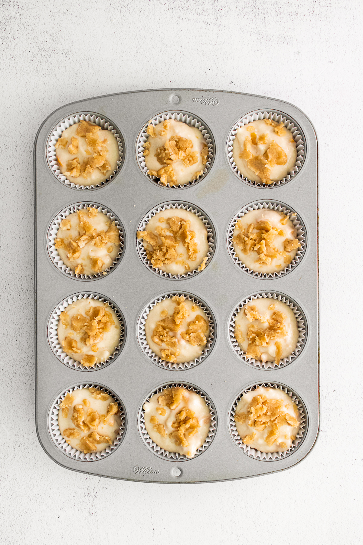Uncooked muffins in a pan. 