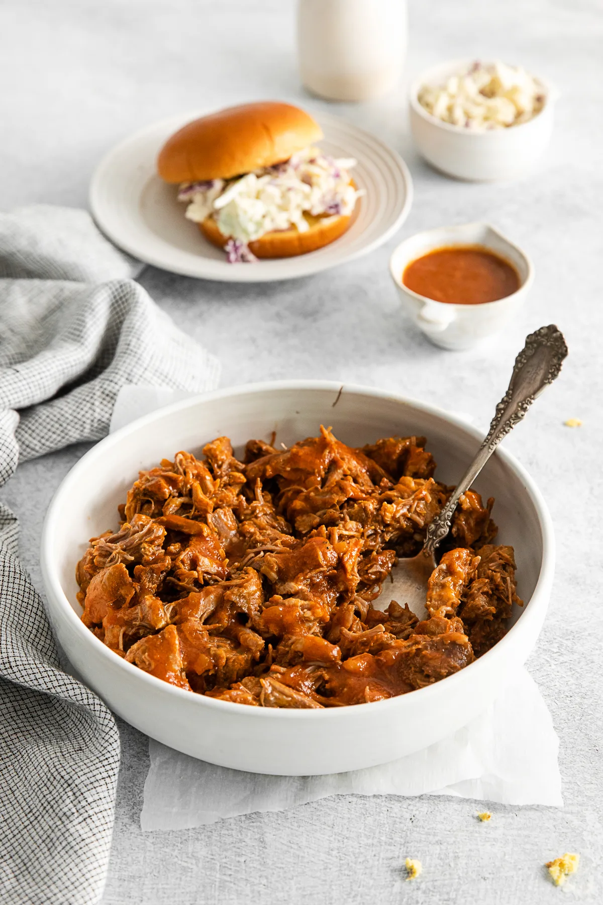 Slow Cooker BBQ Pulled Pork in a bowl with a serving spoon. 