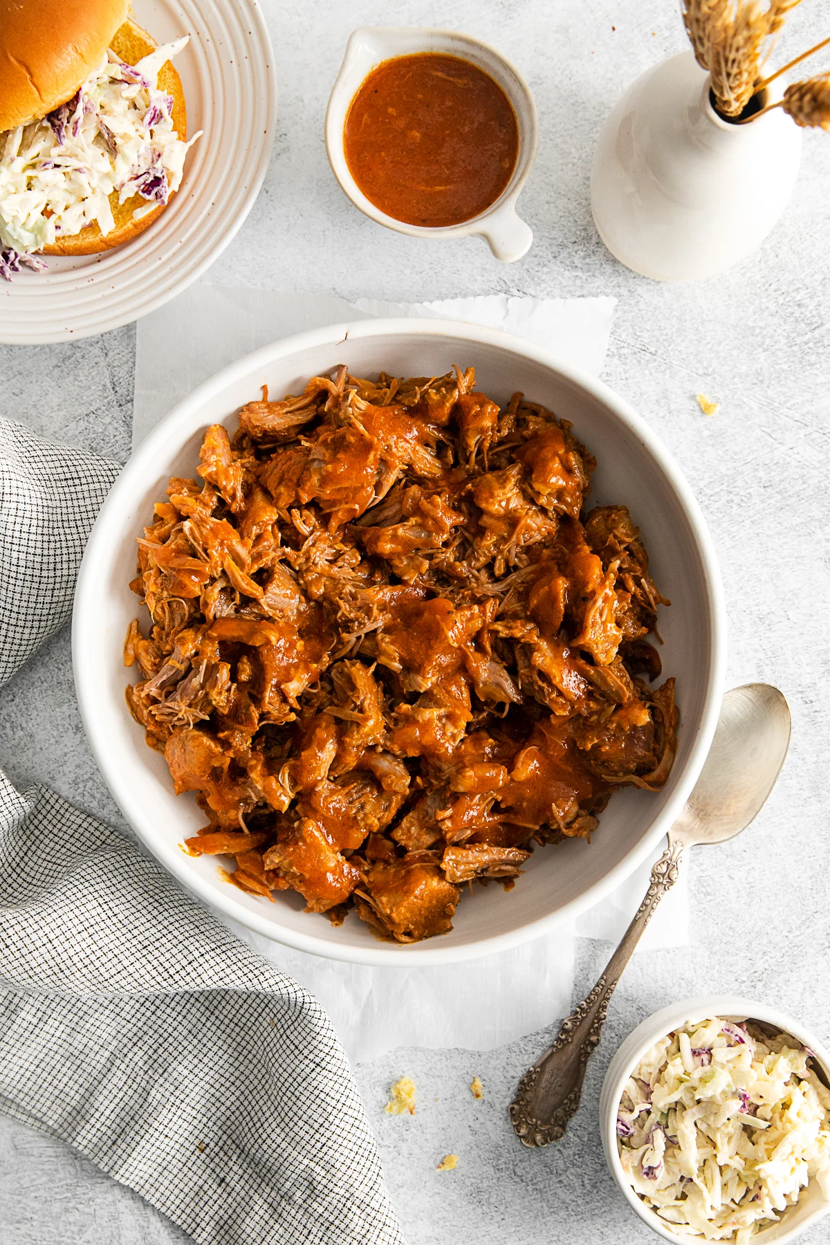 Slow Cooker BBQ Pulled Pork in a bowl on a table with a napkin. 