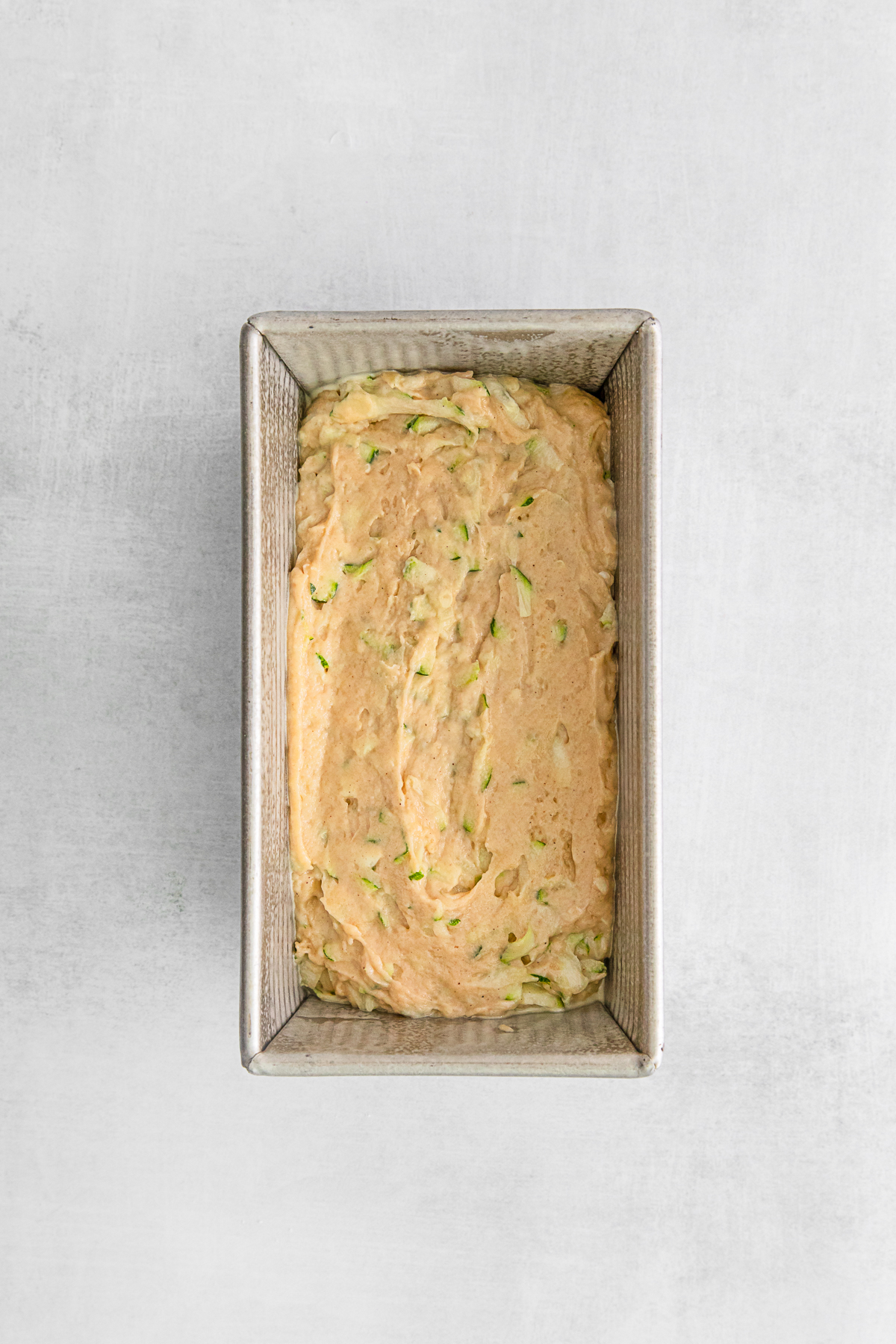 Uncooked Zucchini Bread in a pan. 