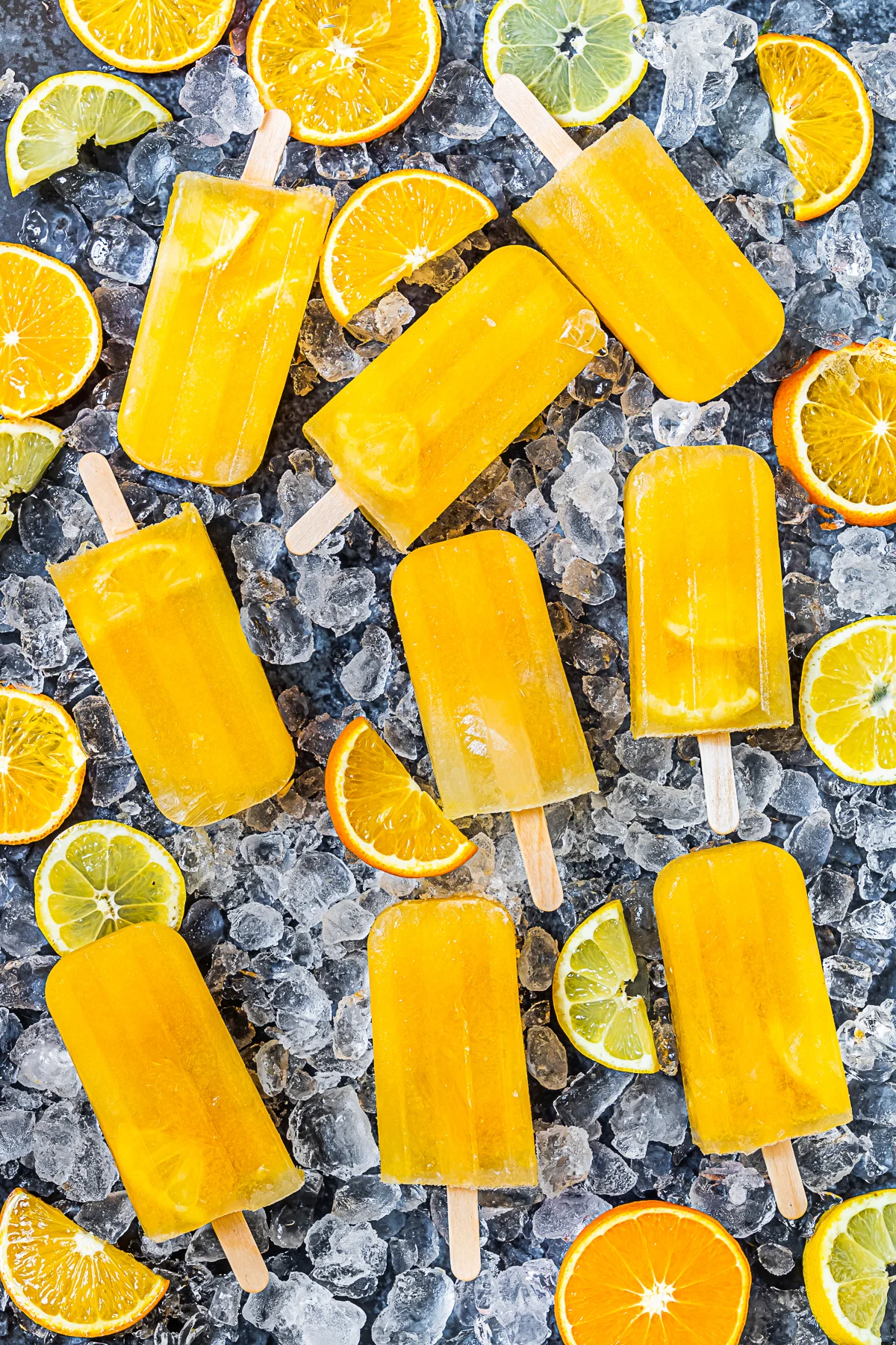 Citrus Popsicles on a table with ice. 
