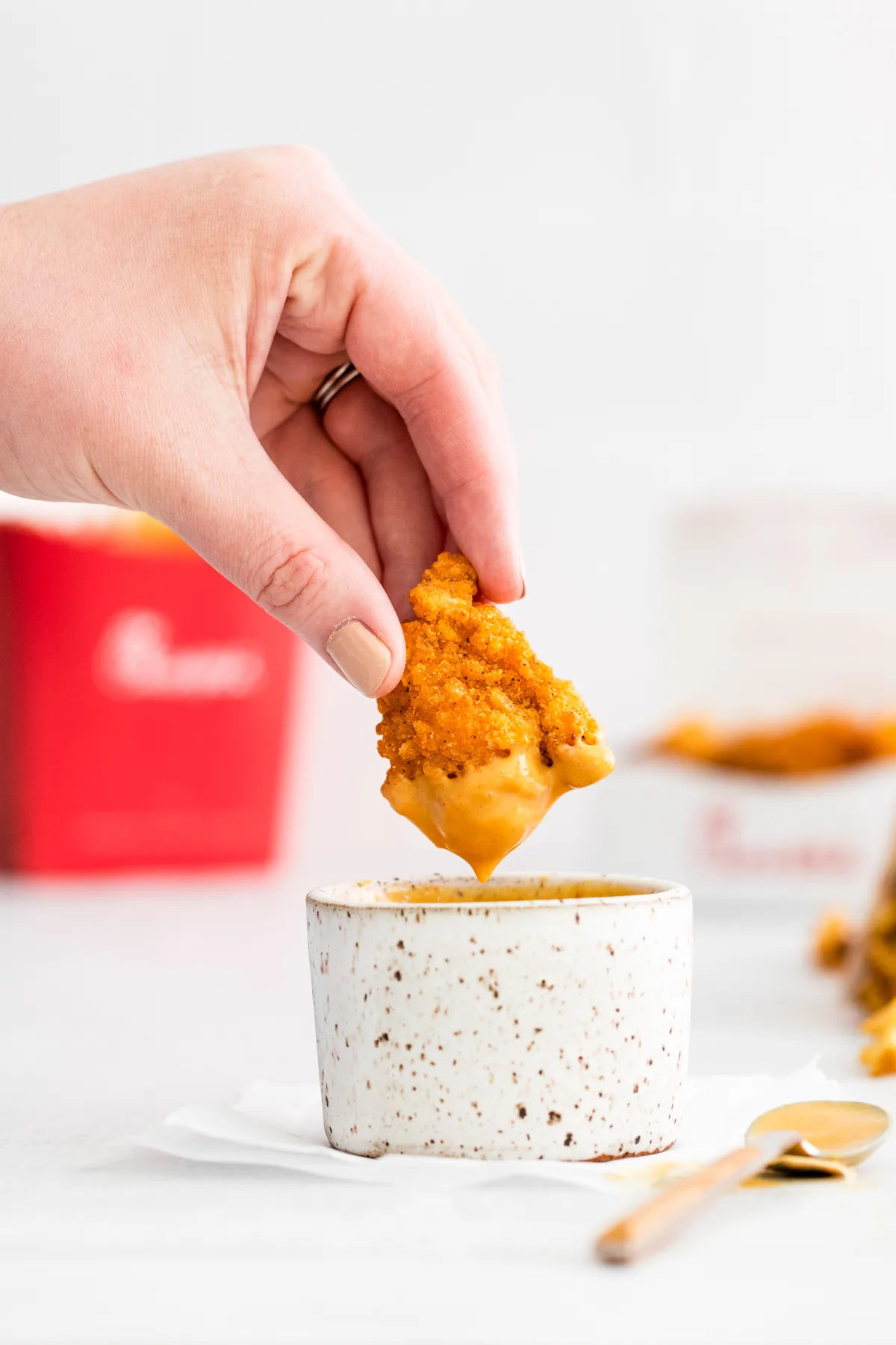 Dipping a chicken nugget into homemade Chick-fil-A Sauce. 
