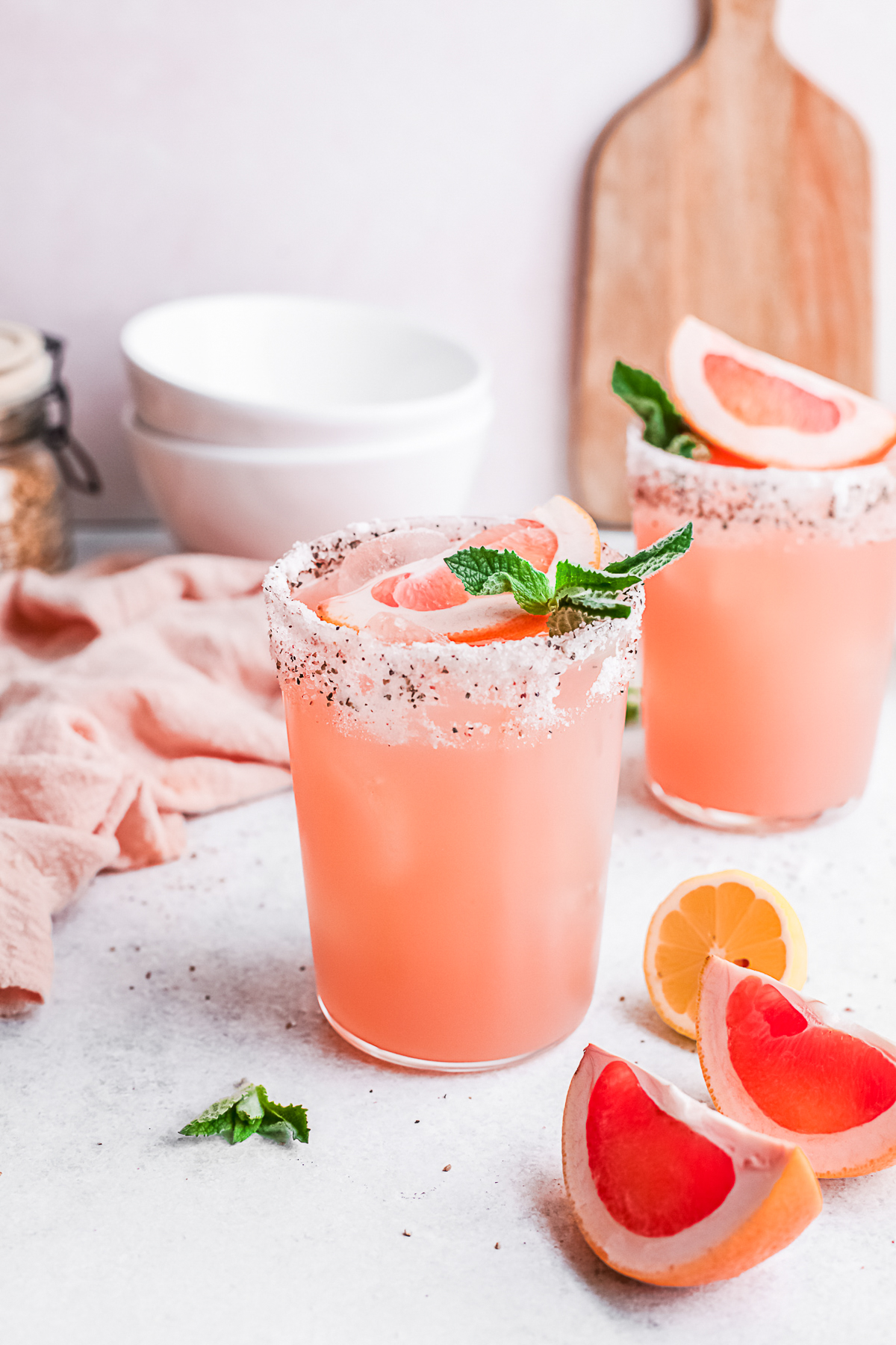 Grapefruit Paloma in a glass with a salt and pepper rim. 