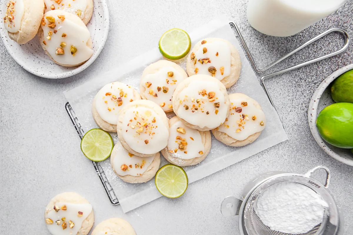 Lime Glazed Sugar Cookies on a table glazed and topped with nuts. 