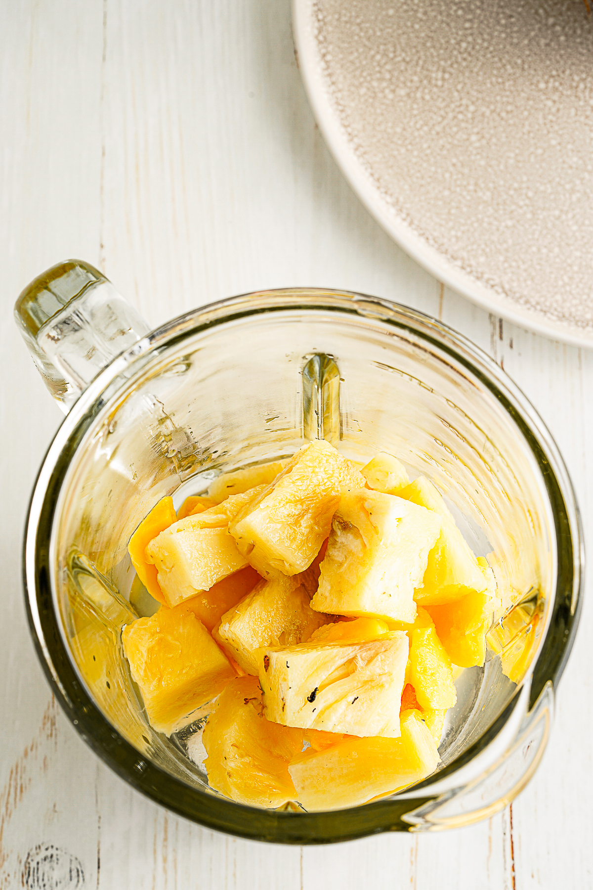 frozen pineapple and mango in a blender. 