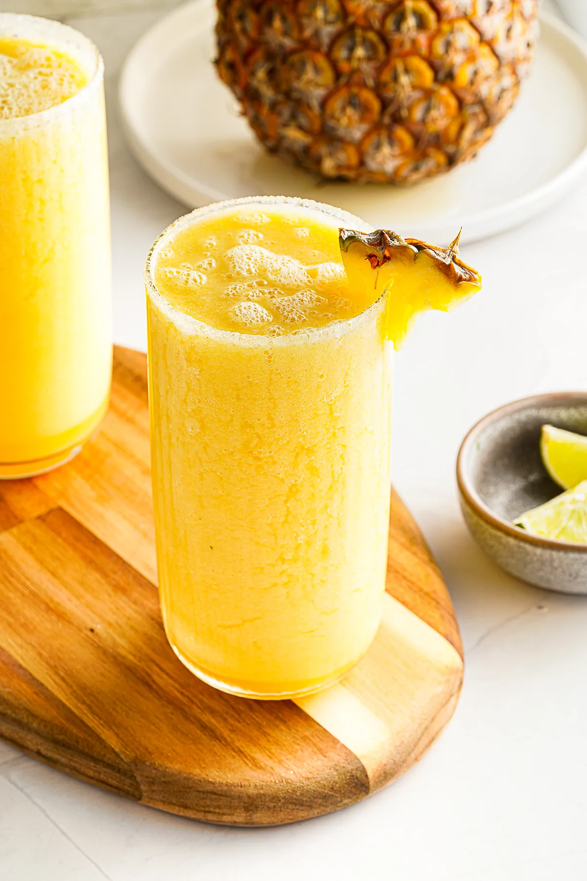 Mango Pineapple Smoothie with fresh pineapple in the background. 