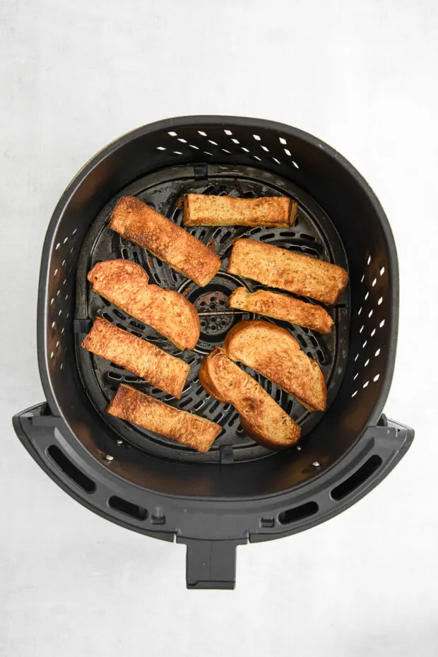 Air Fryer French Toast Sticks in the air fryer basket. 