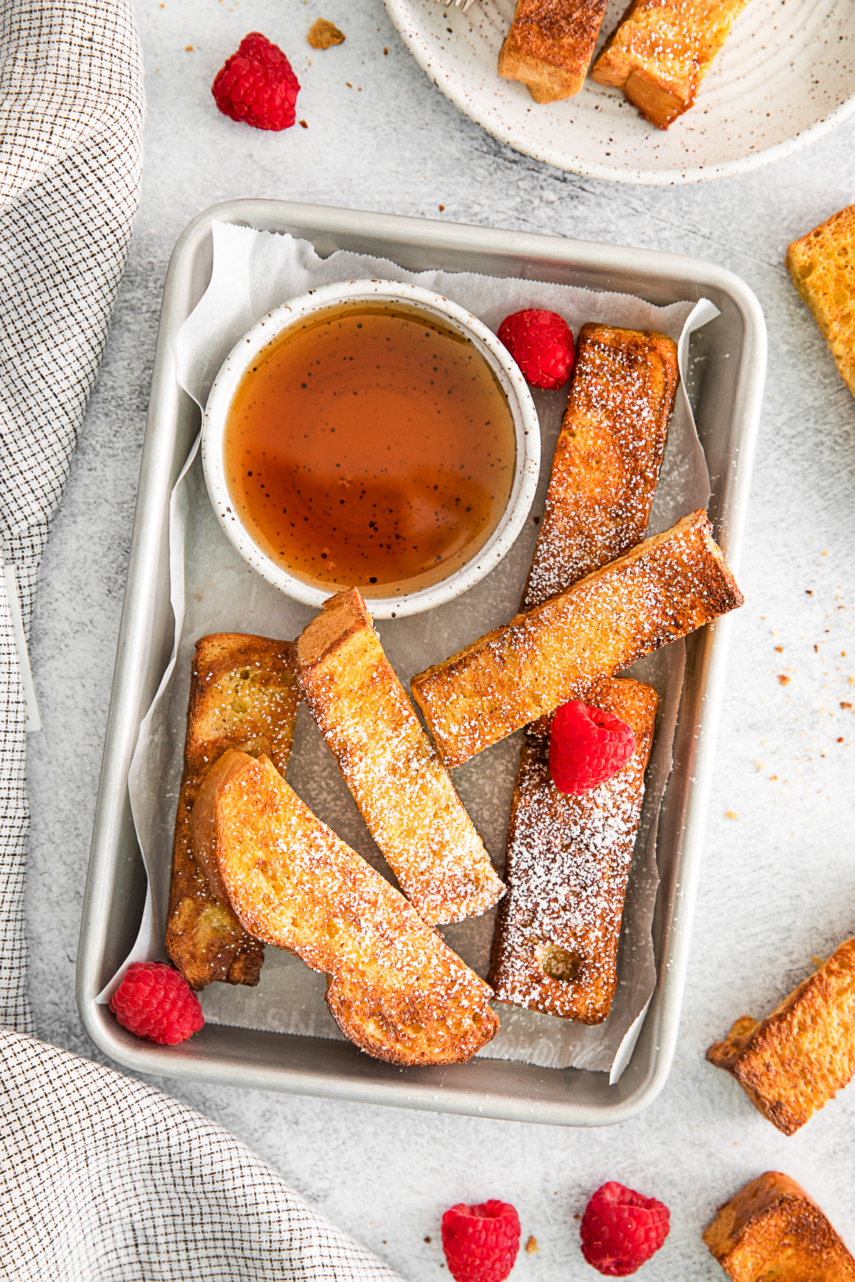 Air Fryer French Toast Sticks served with maple syrup. 