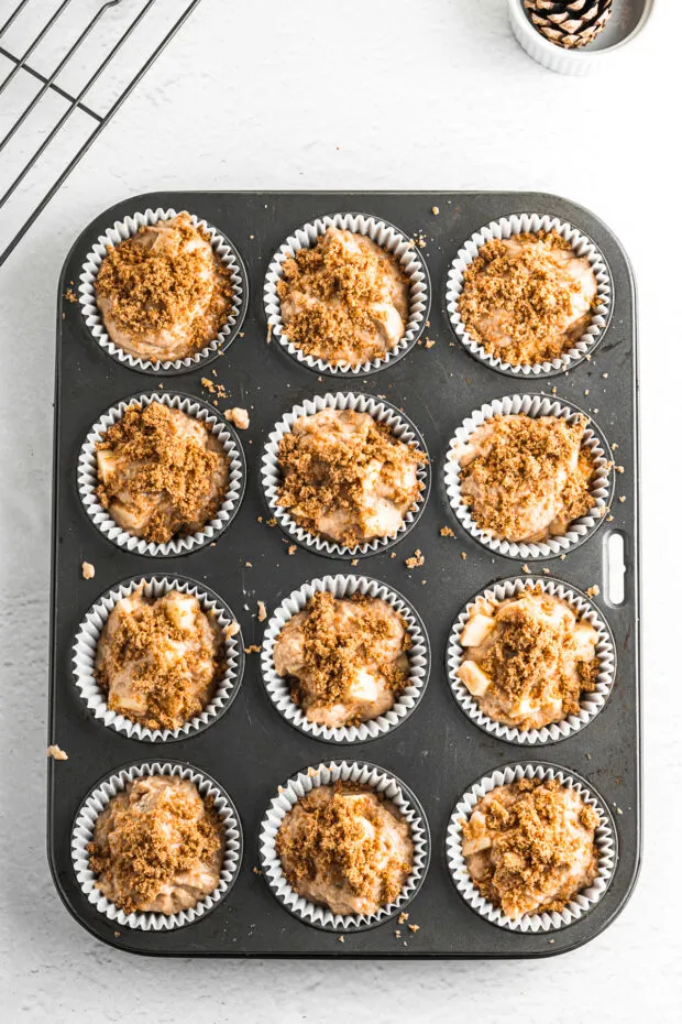 Uncooked muffins in a tin. 