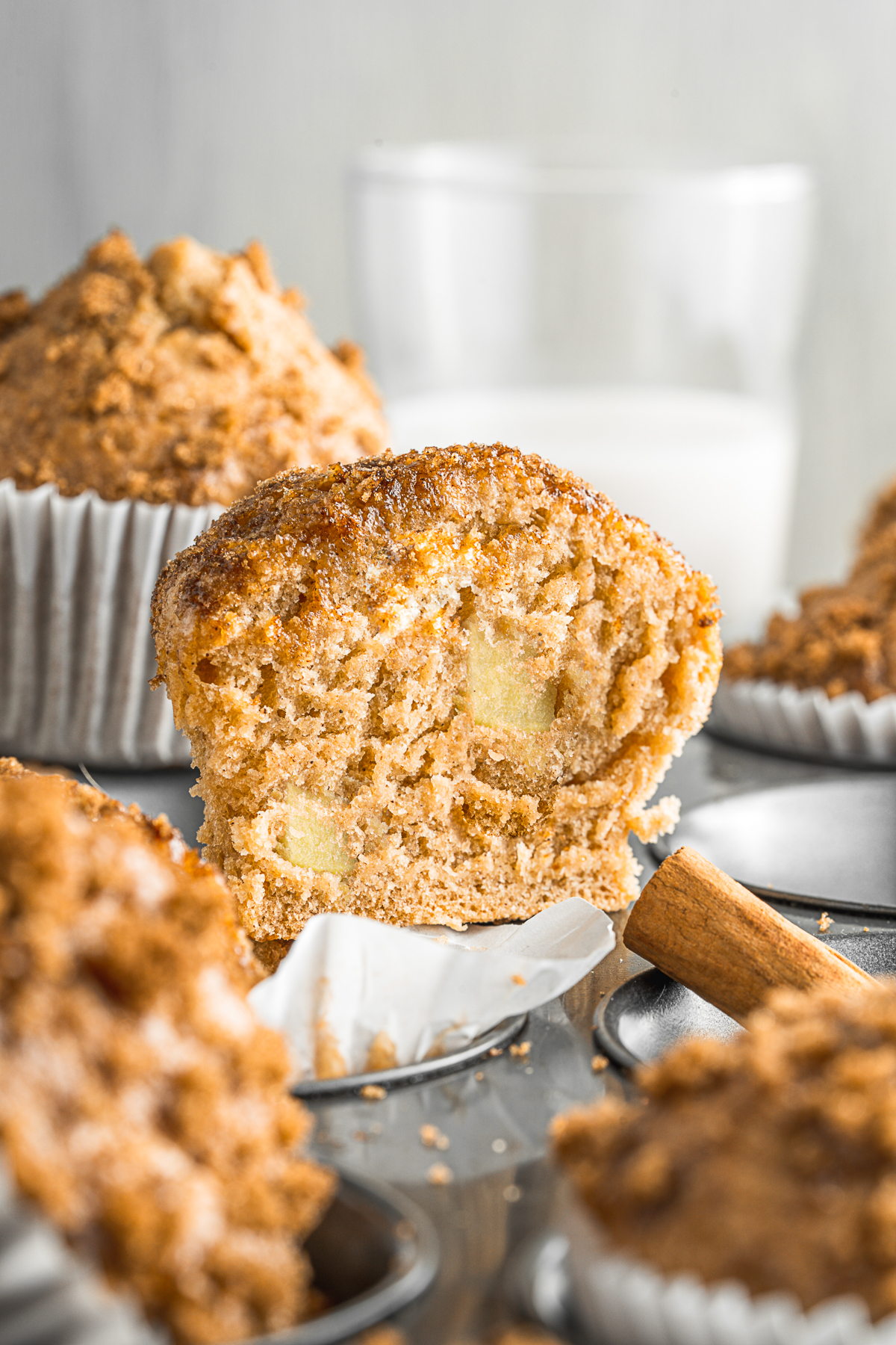 Applesauce Muffins cut in half to show apples in the muffin. 
