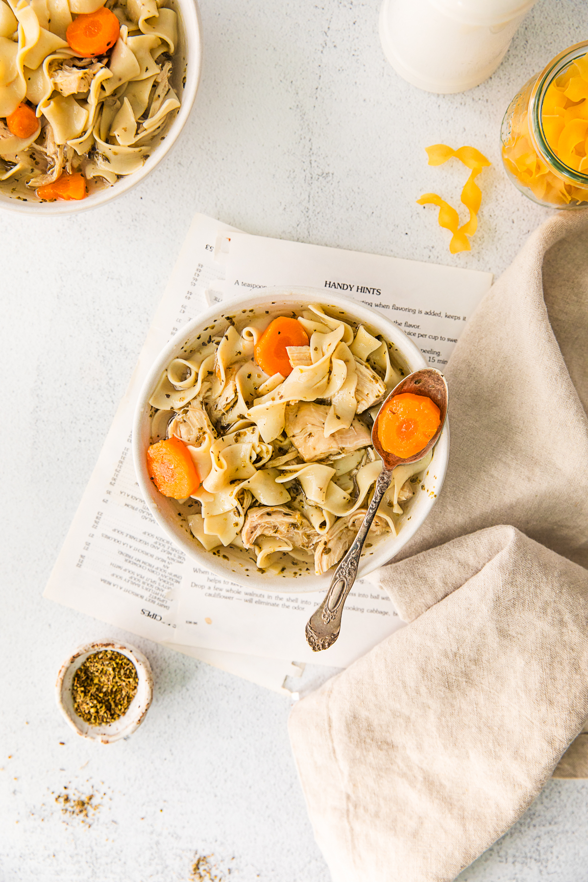 Instant Pot Chicken Noodle Soup in a bowl with a spoon taking a spoonful out of the bowl. 