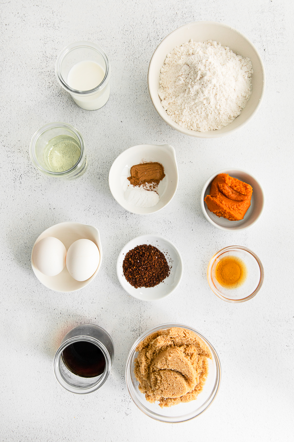Ingredients to make Pumpkin Spice Latte Cupcakes on a table. 