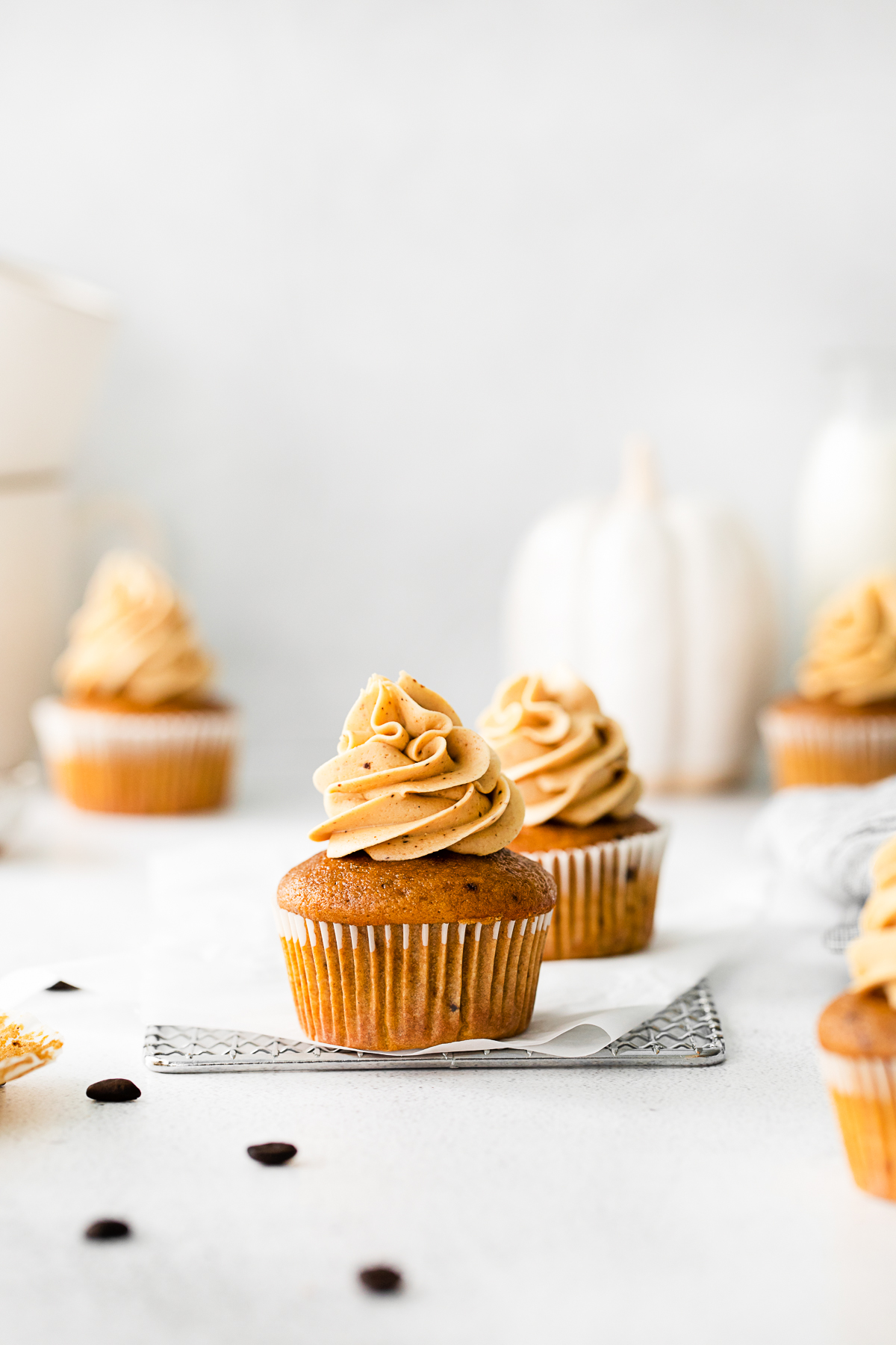 Pumpkin Spice Latte Cupcakes sitting on a table. 