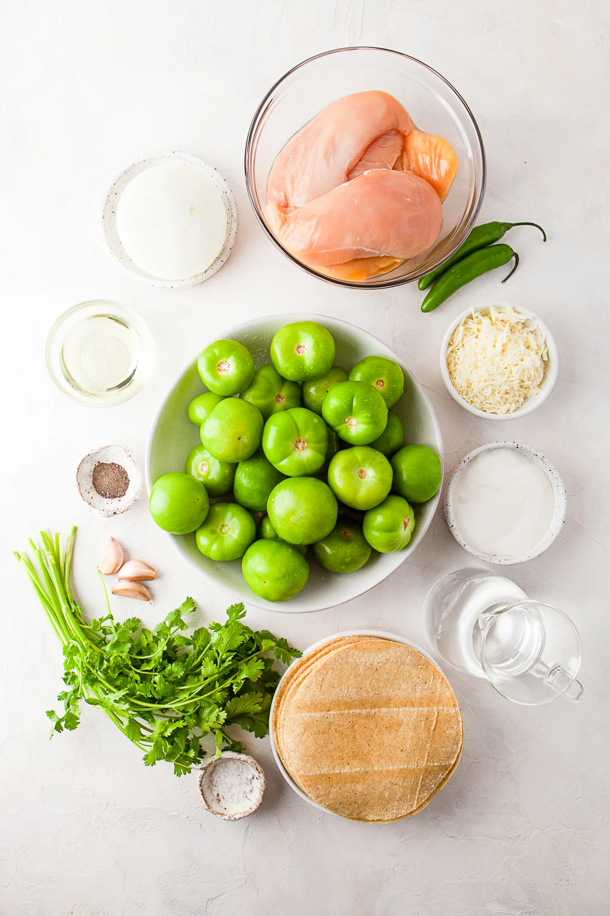 Ingredients to make Salsa Verde Chicken Enchiladas on a table. 