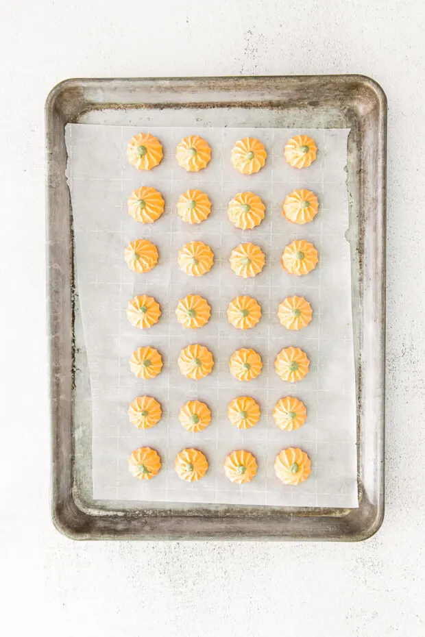 Pumpkin Spice Meringue Cookies uncooked on a baking sheet pan. 