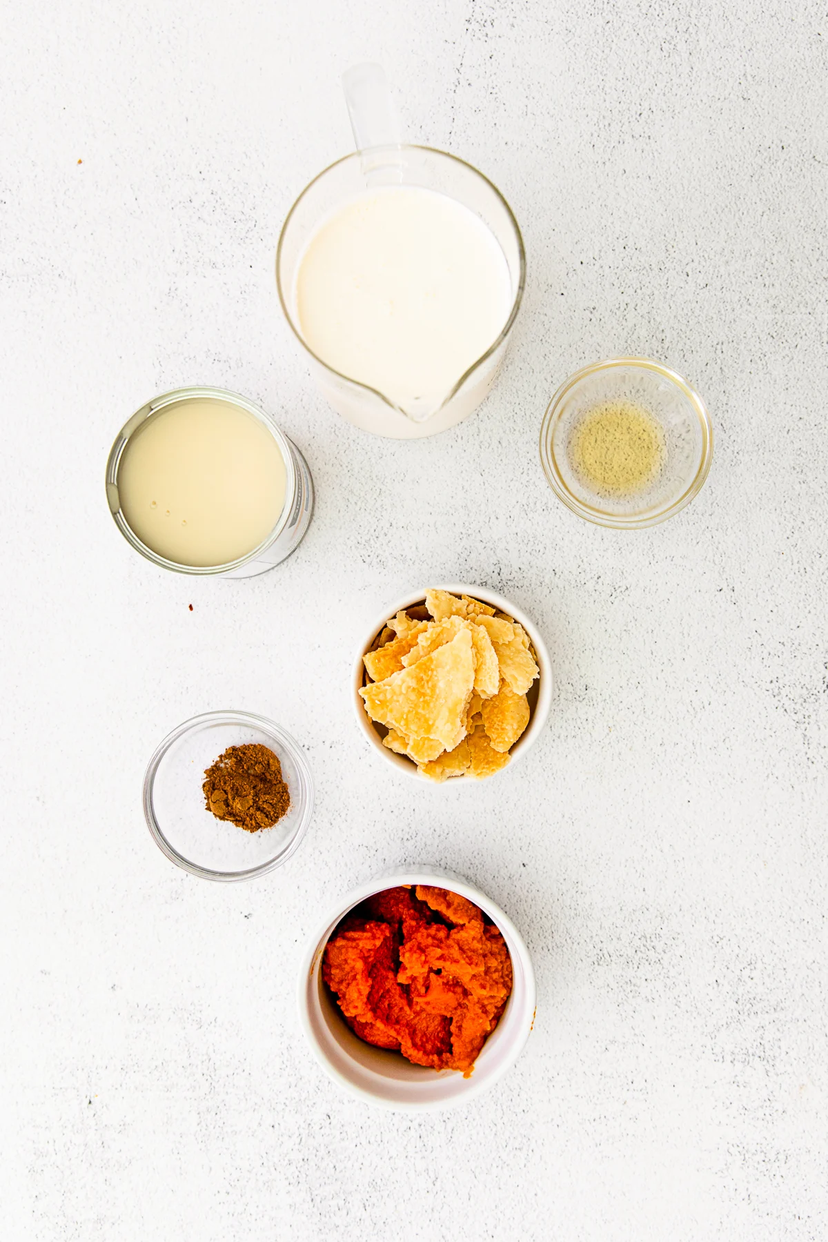 Ingredients to make pumpkin pie ice cream on a table. 