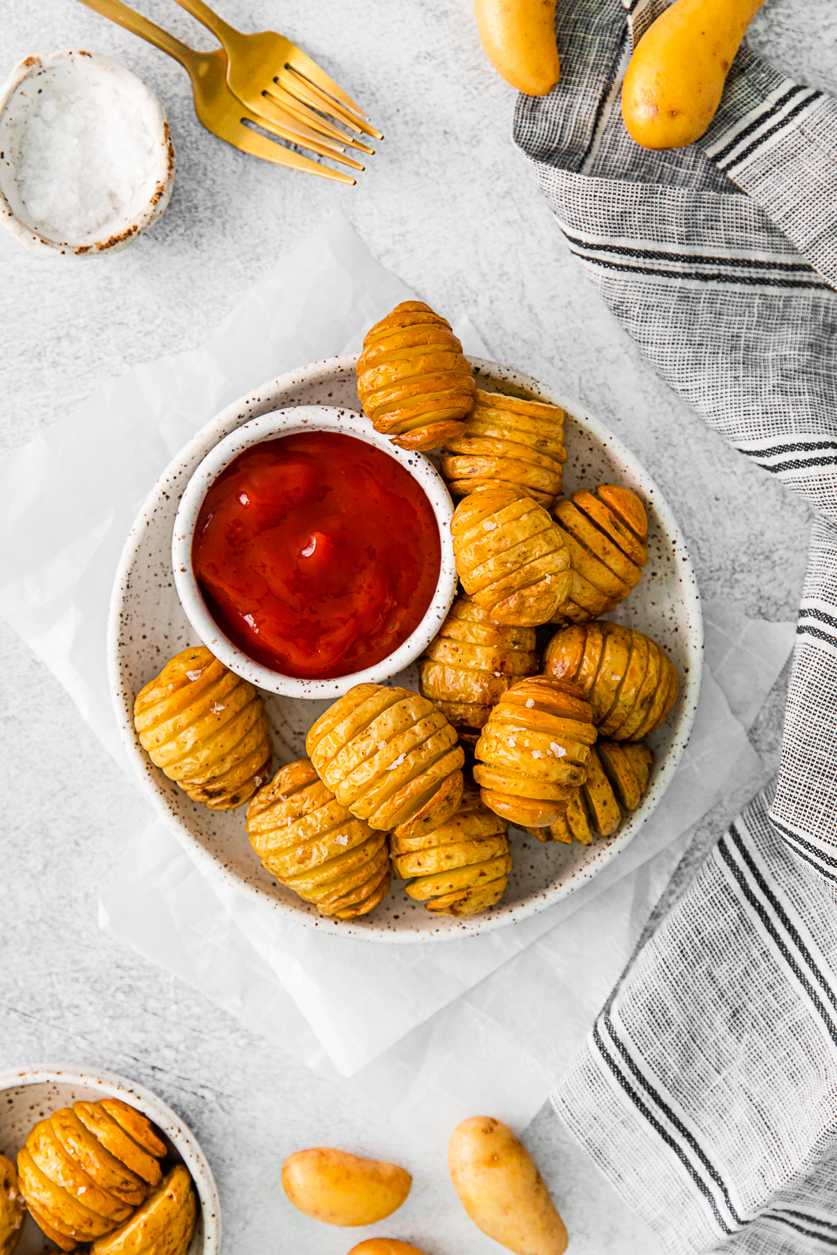 Air Fryer Hasselback Potatoes on a plate with ketchup. 
