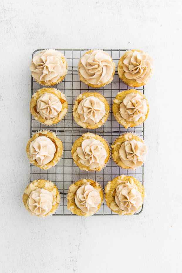 Apple Pie Cupcakes on a cooling rack. 