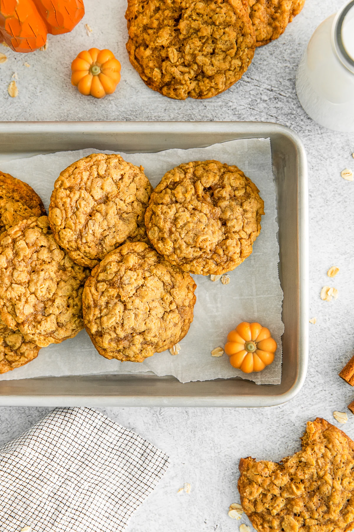 Pumpkin Oatmeal Cookies on a sheet pan with parchment paper. 