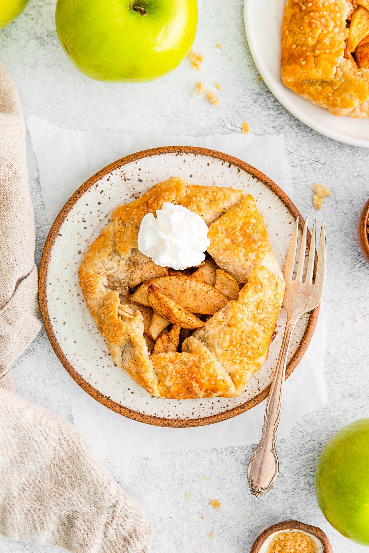 Mini Apple Galette topped with whipped cream. 