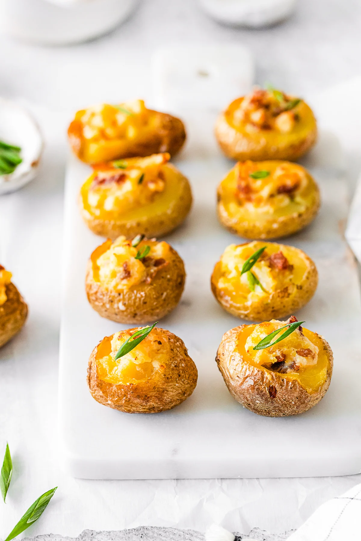 Mini Loaded Baked Potatoes topped with chives. 
