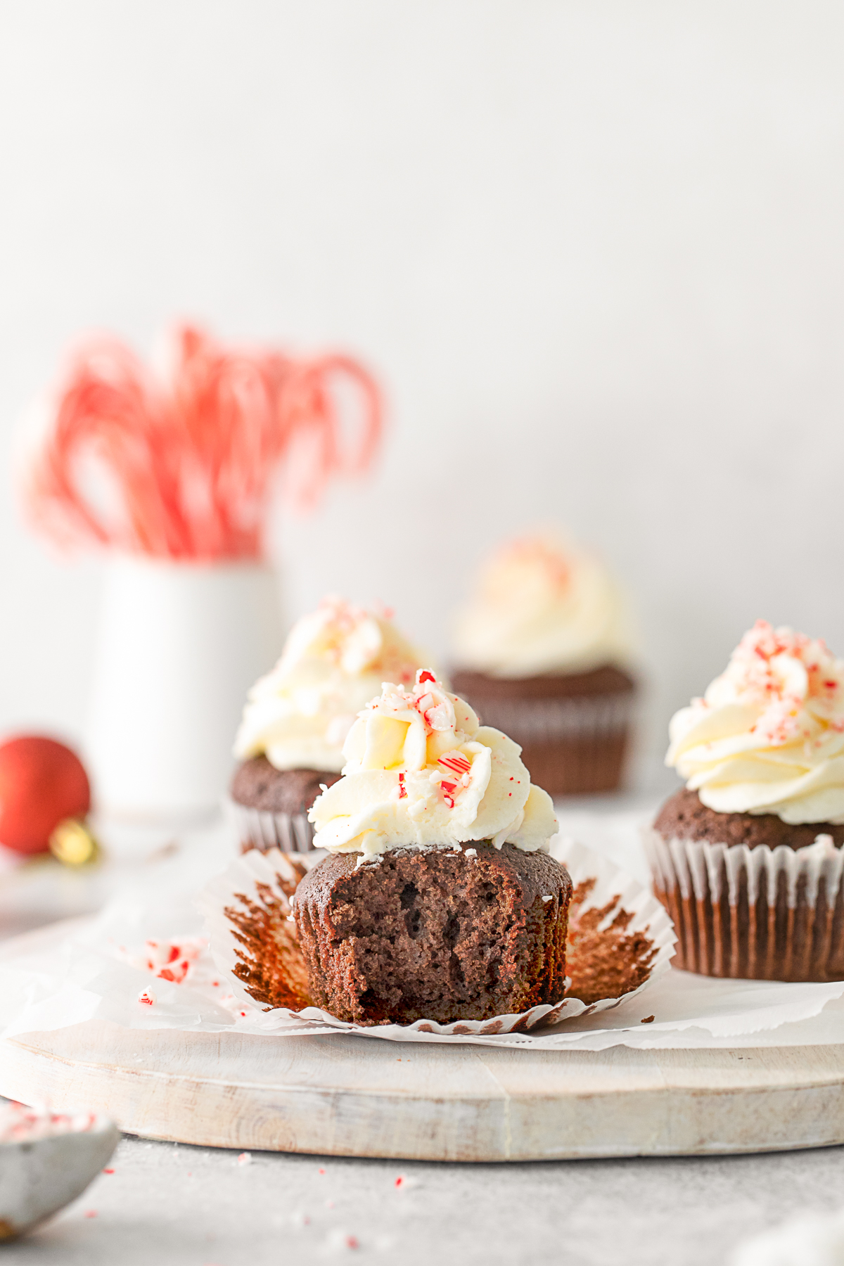 Peppermint Bark Cupcakes with a bite taken out of it. 