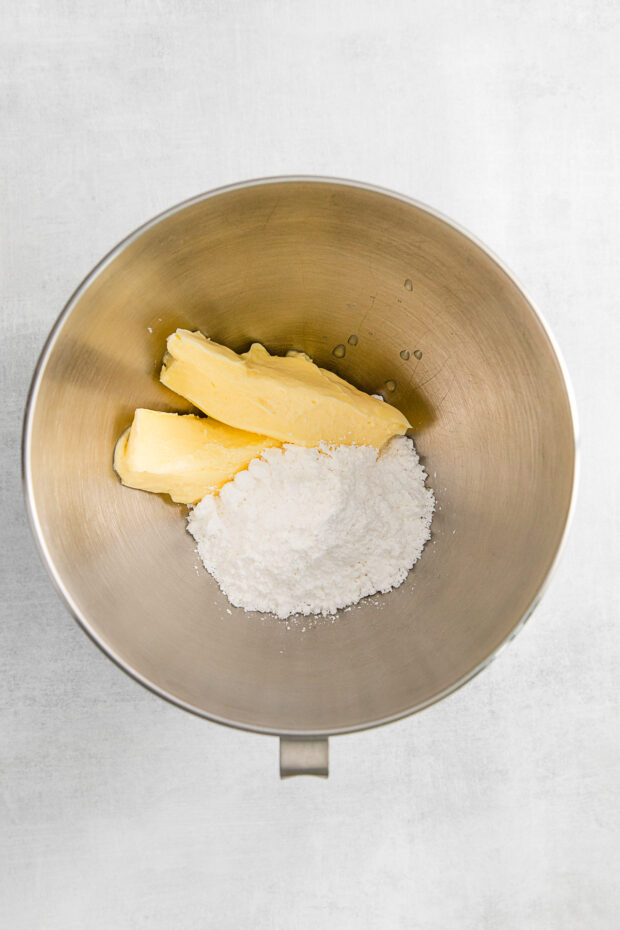 Powdered sugar and butter in a mixing bowl. 