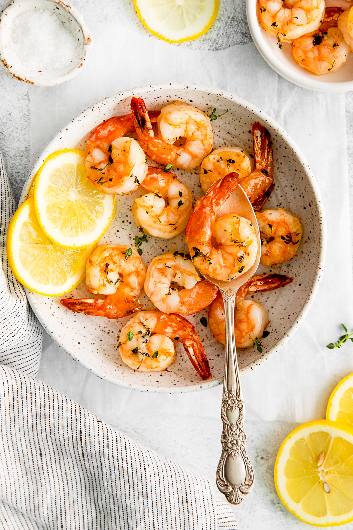 Air Fryer Shrimp in a bowl with a serving spoon. 