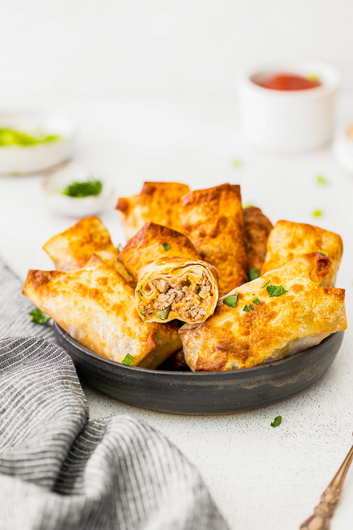 Air Fryer Cheeseburger Egg Rolls cut in half to show filling. 