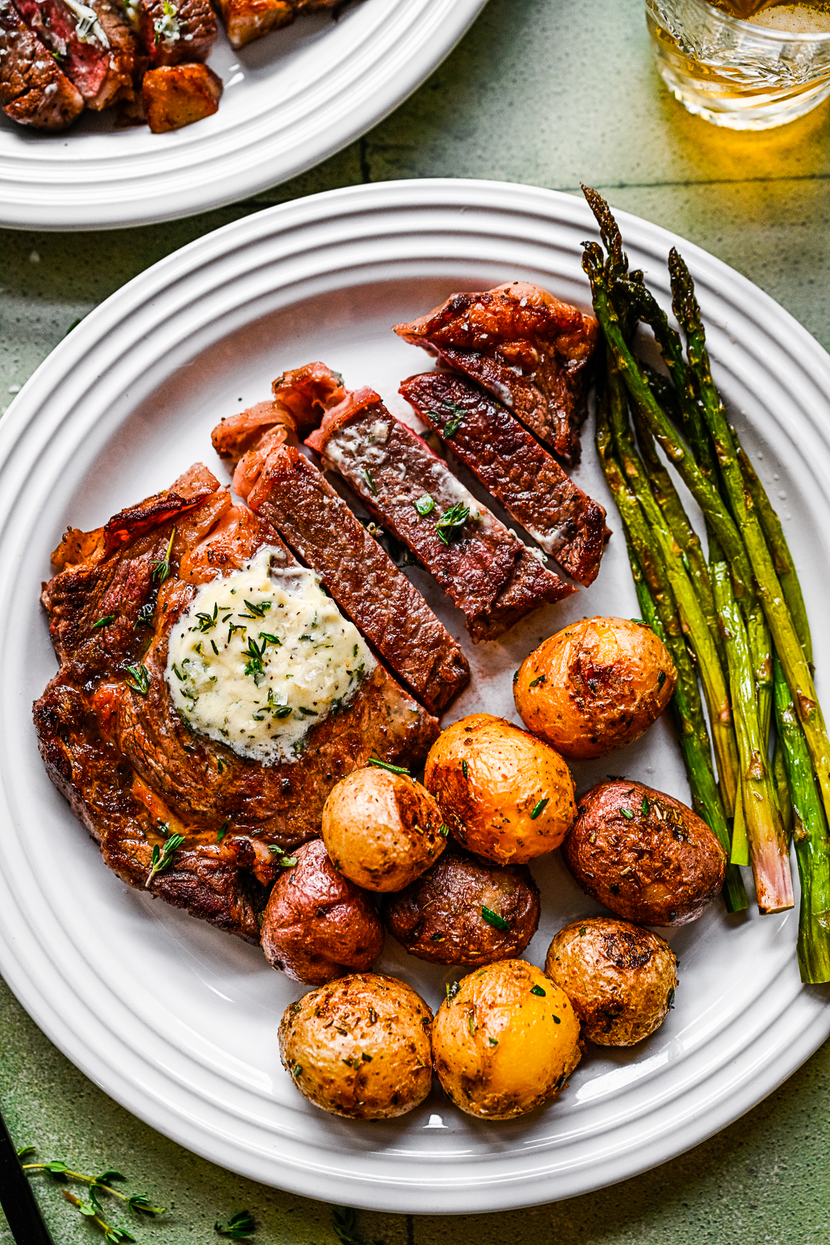 Pan Fried Ribeye on a plate with asparagus and potatoes. 