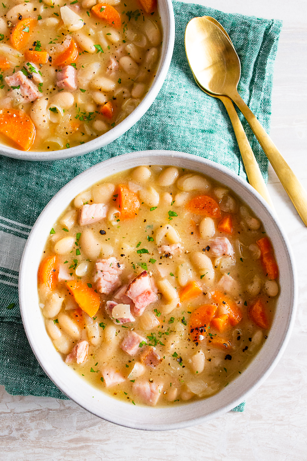easy ham and bean soup topped with fresh parsley and pepper. 