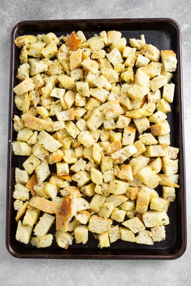 Uncooked homemade croutons on a sheet pan. 