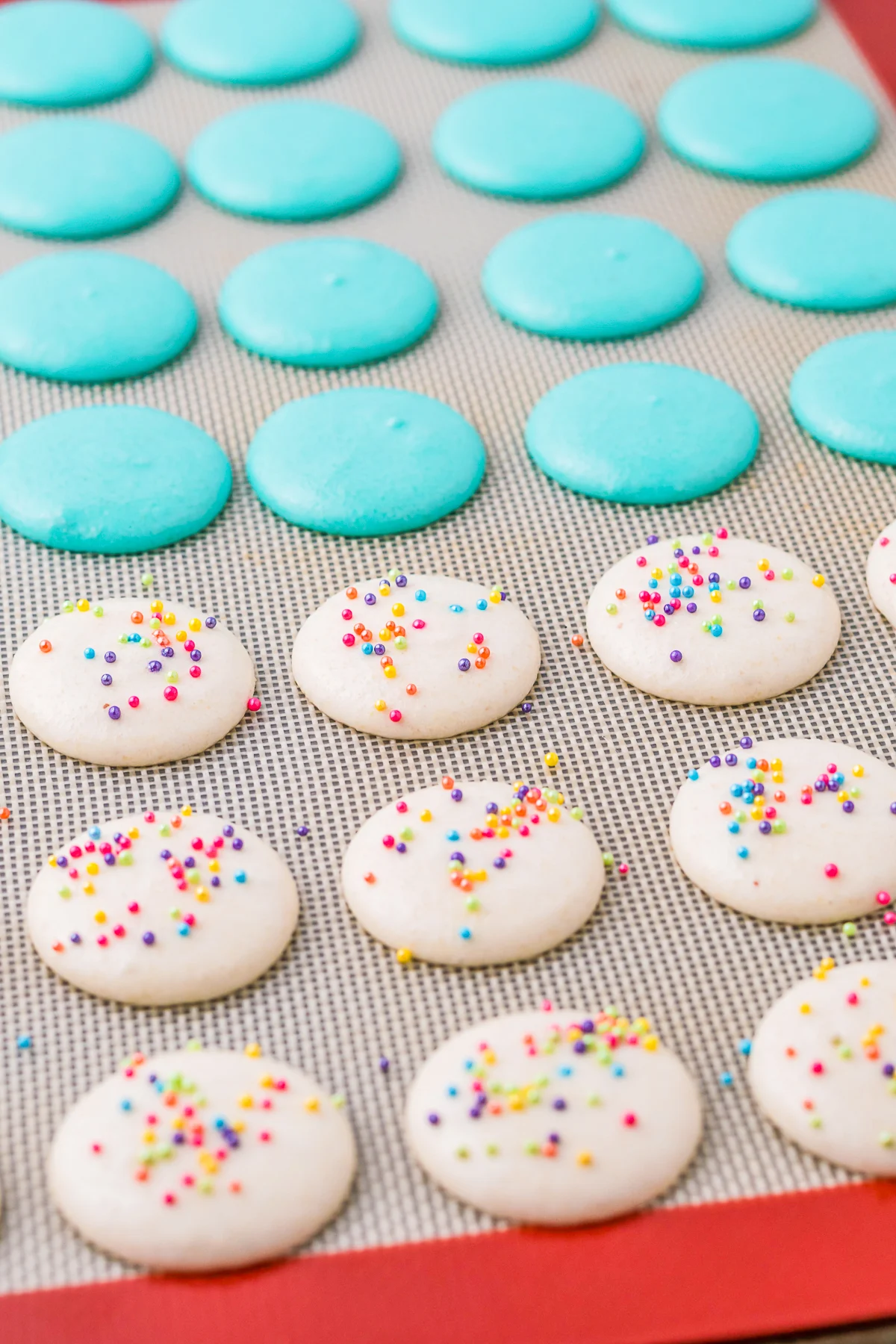 birthday cake macarons uncooked on a silpat liner