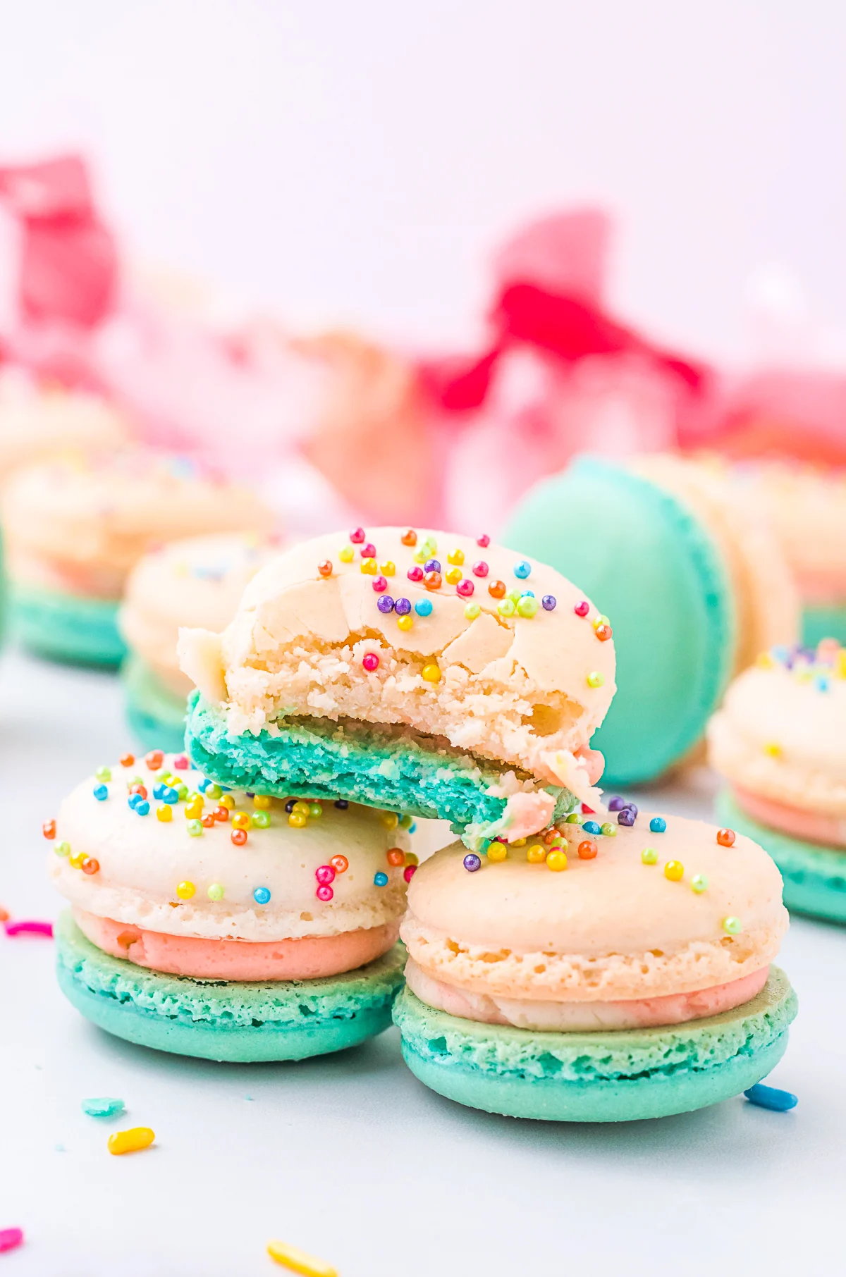 birthday cake macarons with a bite taken out of it