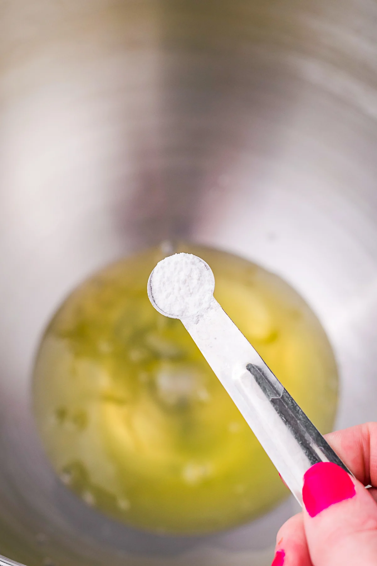 Cream of tartar on a measuring spoon. 