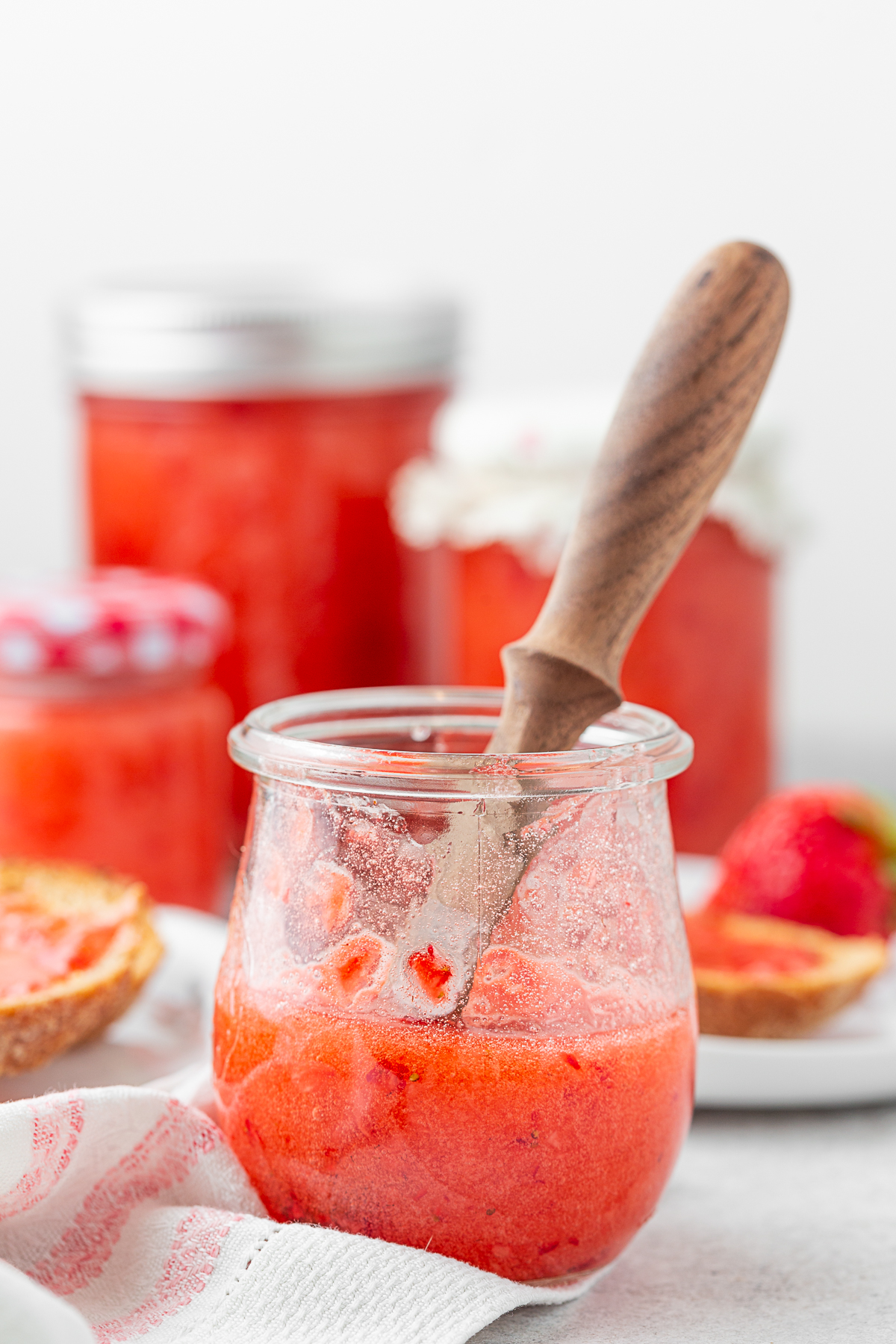 Strawberry Freezer Jam in a small glass jar. 